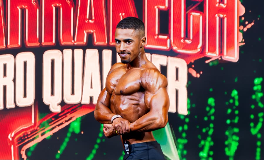 Youness side chest pose on stage
